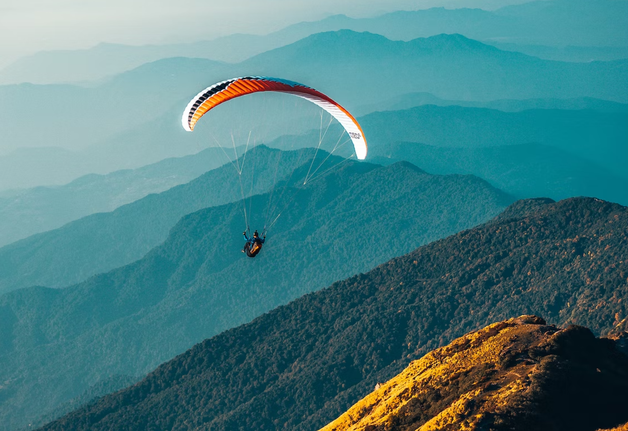 Image of parachuting among mountains